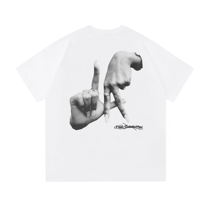 White oversized tee with black hand gesture graphic and Saludo Estevan Oriol logo on chest