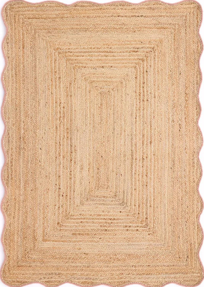 Beige braided rug with scalloped edge on a white background