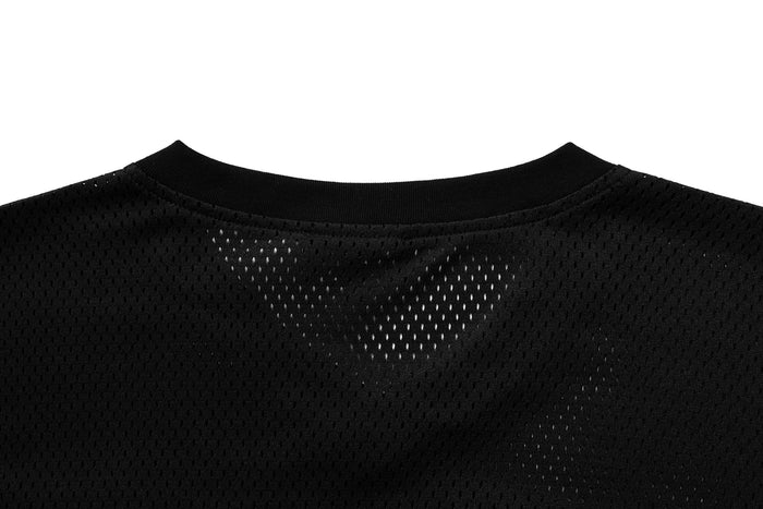 Black mesh jersey close-up showing ribbed crewneck collar and perforated fabric