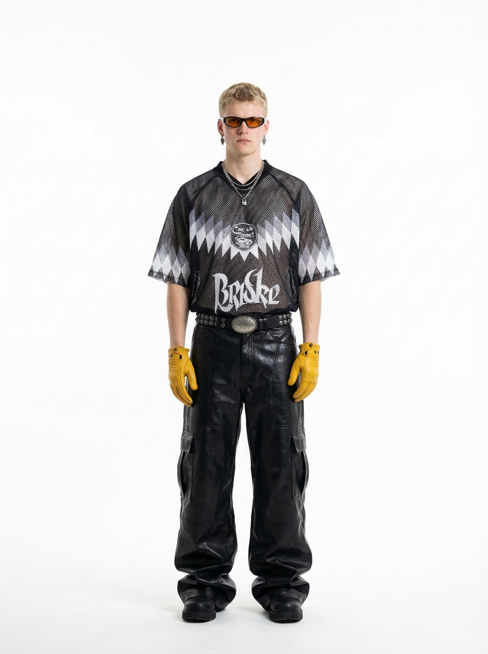 Black mesh soccer jersey T-shirt with zigzag graphic and oversized streetwear fit on model