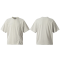 Front and back view of a light stone oversized cotton tee with an asymmetric curved front seam and tonal micro-logo