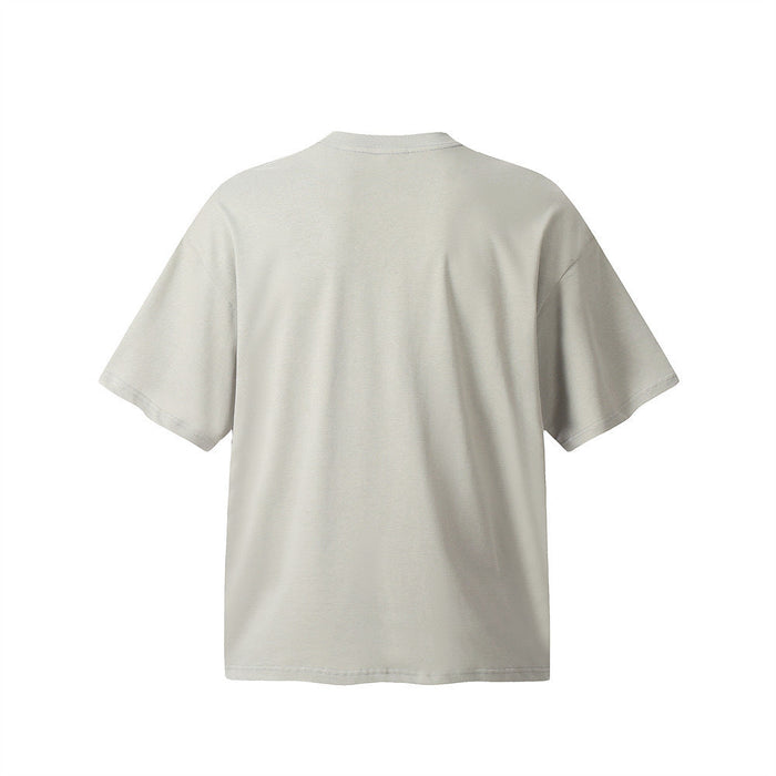 Light beige oversized cotton tee with a clean back view, dropped shoulders, and minimalist deconstructed stitching