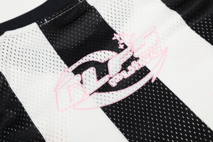 Close-up of pink GLFS Pulse graphic on black and white striped jersey fabric