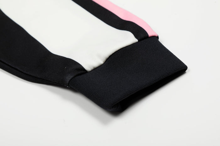 Cuffed sleeve hem on black and white striped jersey with pink side stripe