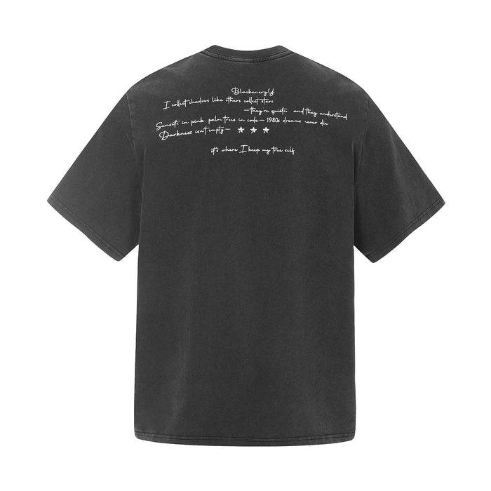 Black vintage washed graphic T-shirt with handwritten text print on the back and relaxed short sleeves