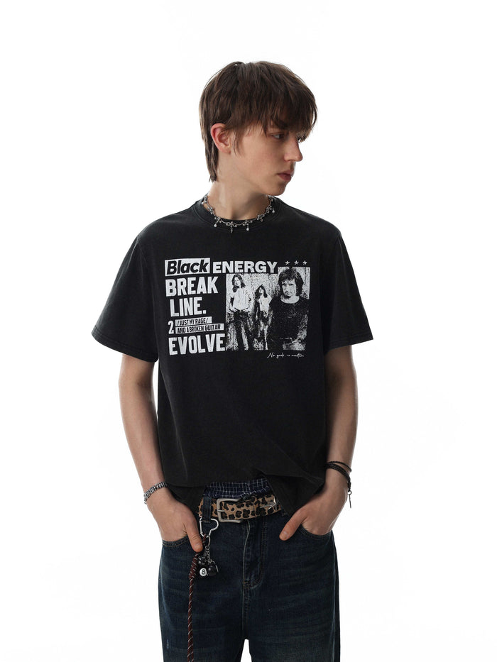 Black vintage washed graphic T-shirt with bold rock-inspired print, worn with dark jeans and layered streetwear accessories