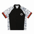 Black button-up shirt with gray camo sleeves, red stripe cuffs, and circular eagle patch on chest