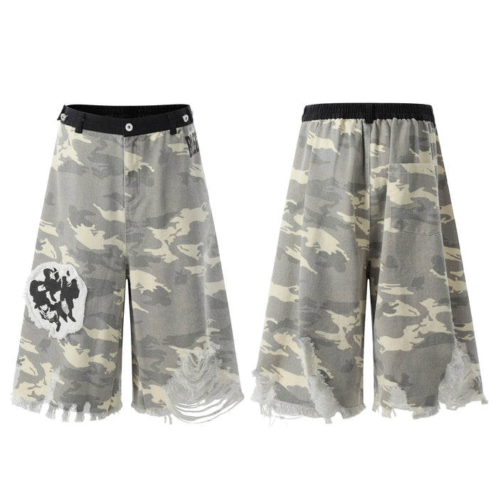 Front and back view of grey camo wide-leg distressed jorts with frayed hem, black waistband, and graphic patch