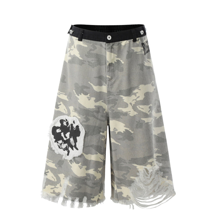 Front view of gray camo wide-leg jorts with black waistband, distressed patches, and frayed hems