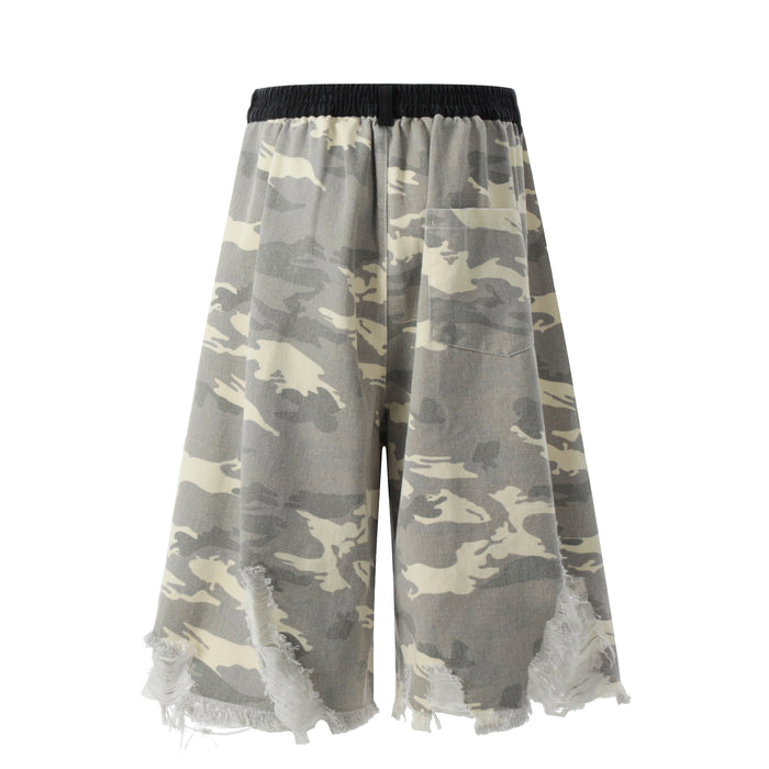 Back view of gray camouflage wide-leg shorts with elastic black waistband and frayed hem details