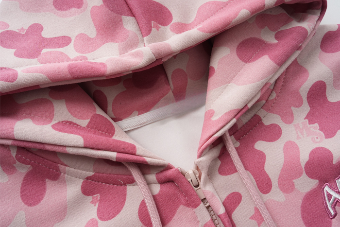 Close-up of pink camo hoodie neckline, zipper, and hood opening
