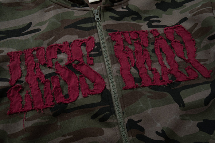 Close-up of burgundy chenille varsity lettering on camouflage hoodie front