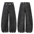 Front and back view of black wide-leg balloon pants with crocodile texture print and white star embroidery at waistband and h