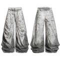 Front and back view of grey dirty wash balloon jeans with paint splatter detailing and extended white drawstrings