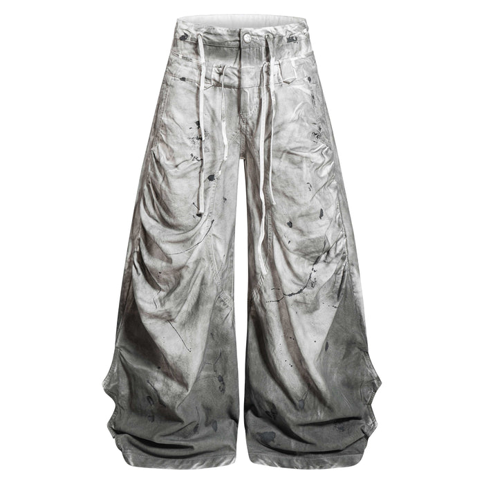 Front view of gray balloon jeans with oversized wide legs and dirty wash splatter