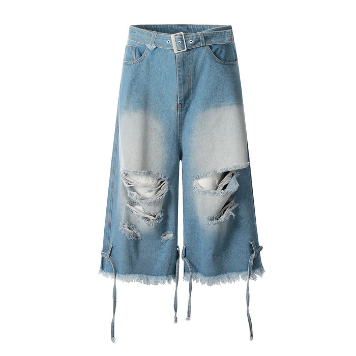 Front view of light blue wide-leg distressed denim jorts with built-in belt, ripped knees, and frayed hem tie straps