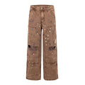 Front view of brown distressed denim pants with paint splatter and ripped knees