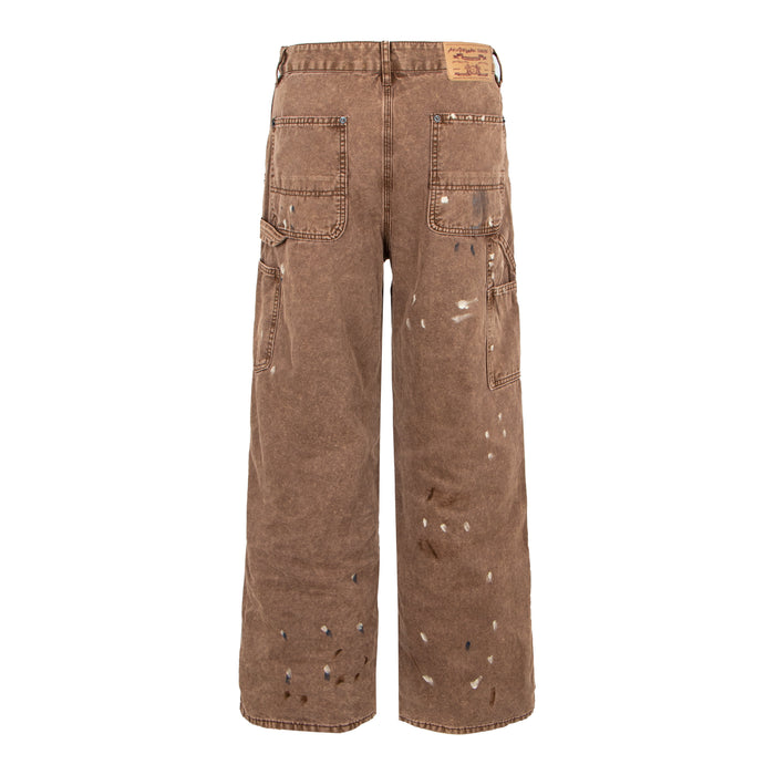 Back view of brown distressed denim pants with patch pockets and paint splatter