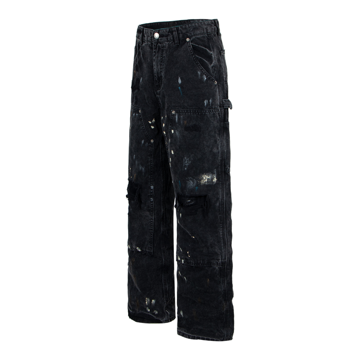 Three-quarter front view of black distressed workwear denim pants with utility pockets