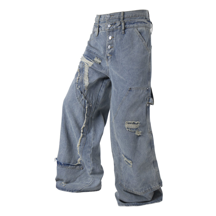 Side front view of light blue distressed denim pants with frayed panel details
