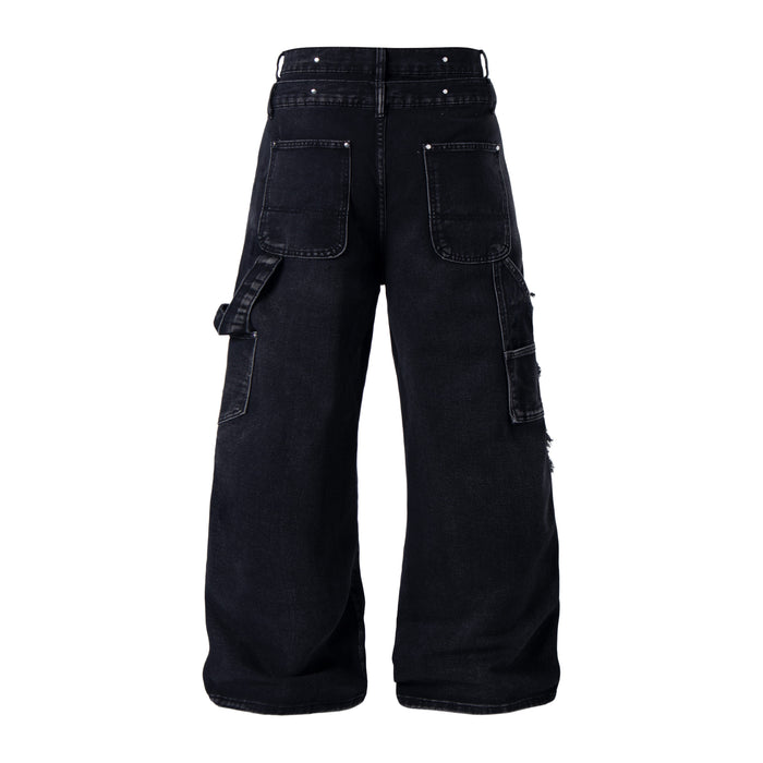 Back view of black distressed denim pants with patch pockets and cargo pocket