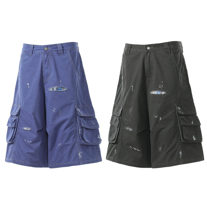 Two pairs of distressed cargo shorts in blue and black, front view with ripped details