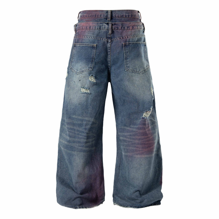 Back view of distressed wide-leg jeans in faded blue denim with patch pockets and ripped details
