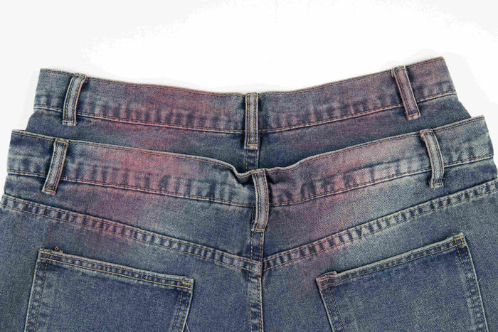 Back waistband close-up of faded wide-leg jeans with belt loops and top pockets