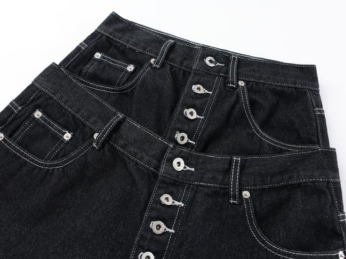 Close-up of the front waist and button fly on black denim pants