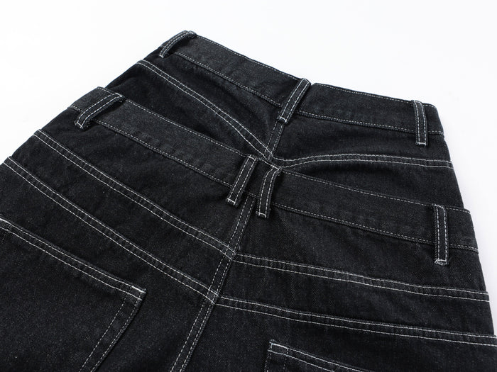 Close-up of the back waistband and belt loops on black denim pants