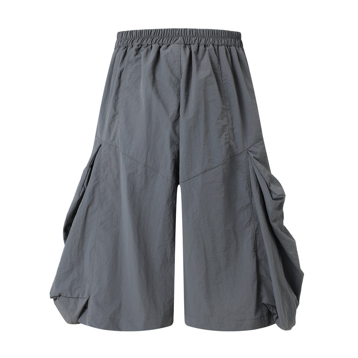 Gray wide-leg shorts, back view with gathered elastic waistband and draped side volume