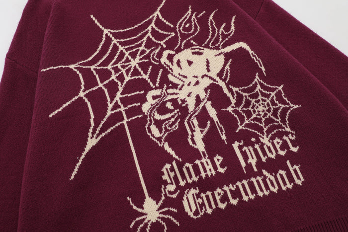Close-up of burgundy sweater front graphic with spider web and gothic text