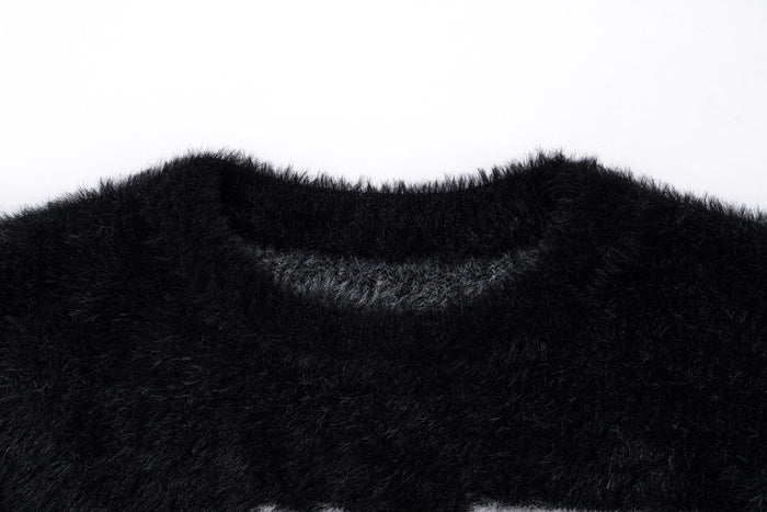 Close-up of the black fuzzy sweater neckline and plush knit texture