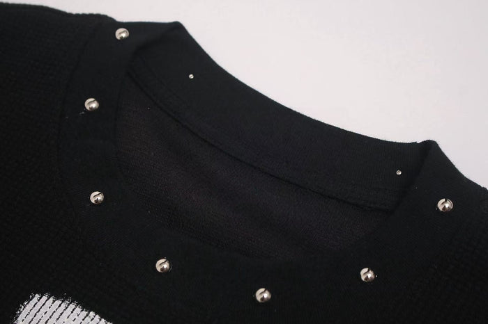 Black oversized gothic tee with metal studs and a distressed cross graphic on soft streetwear fabric