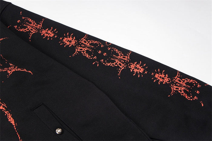 Close-up of black hoodie sleeve with red dragon pattern along the arm