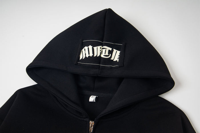 Black hood with white gothic lettering patch near the top