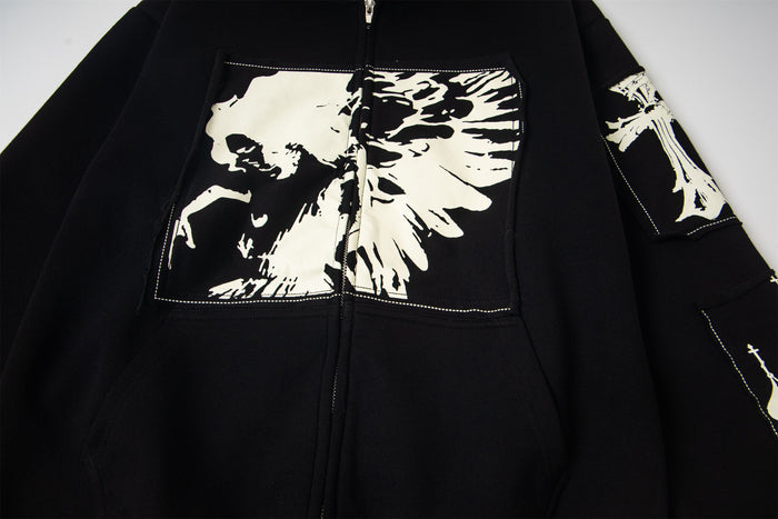 Front chest of black hoodie with large white skull graphic and sleeve print