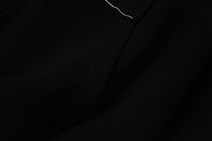 Plain black hoodie fabric close-up with visible stitching detail