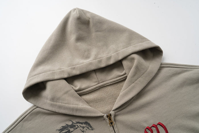 Close-up of taupe hoodie hood and gold zipper at the front neckline