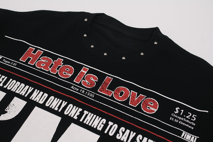 Black streetwear T-shirt with newspaper-style Hate Is Love graphic and bold red and white print on the chest