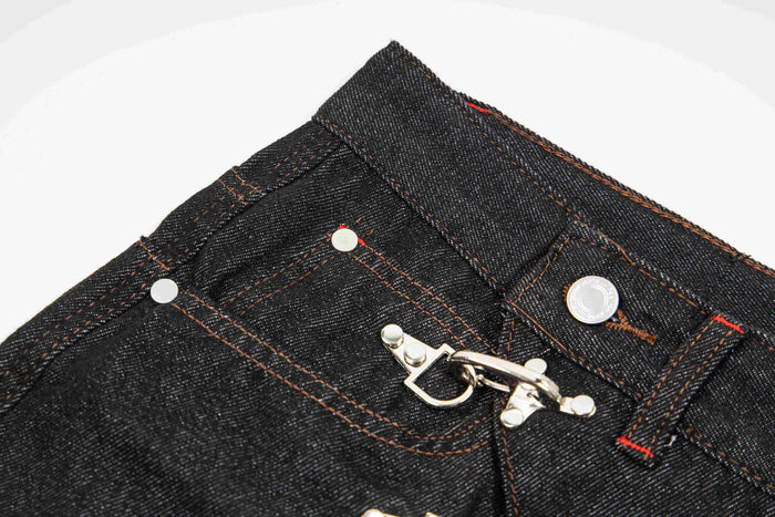 Detail view of dark wash denim waistband with front hook closure and top button