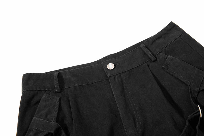 Black shorts waistband and front pocket detail with snap button