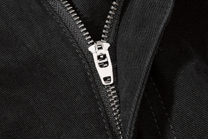 Close-up of black shorts zipper detail on side cargo pocket
