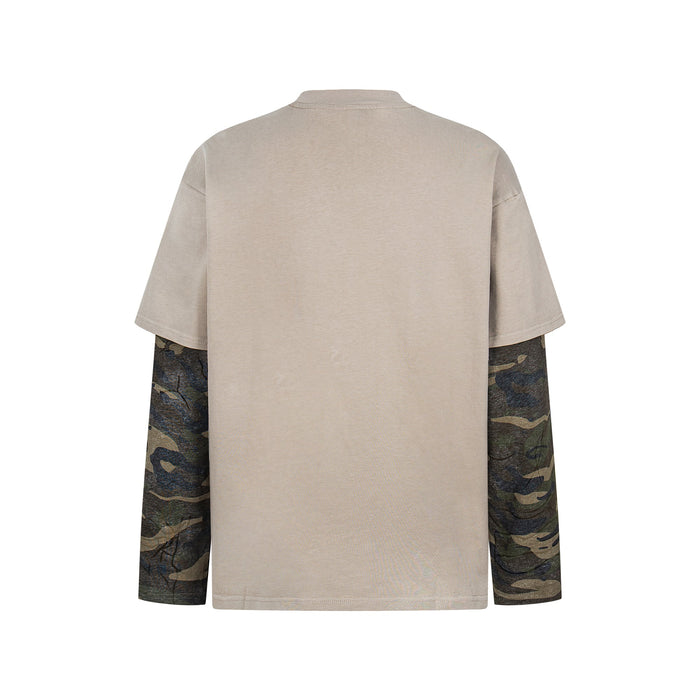 Back view of beige layered tee with camouflage long sleeves and distressed cutout details