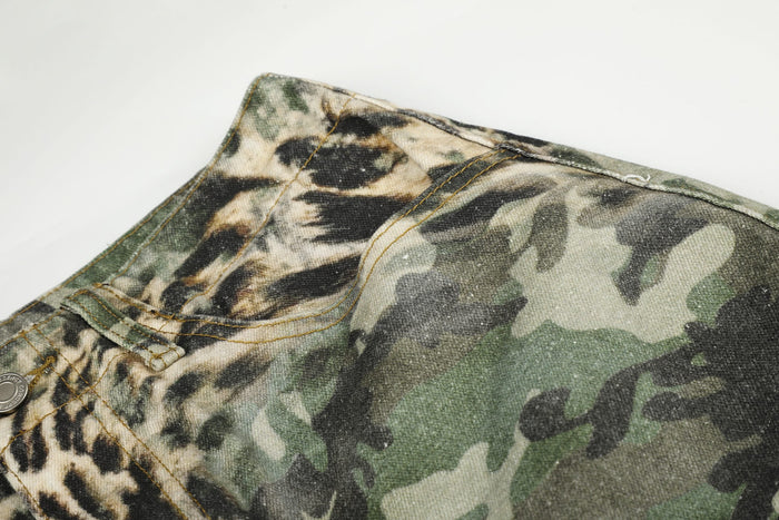 Close-up of side waistband on leopard camo cargo shorts with camo fabric and seam stitching