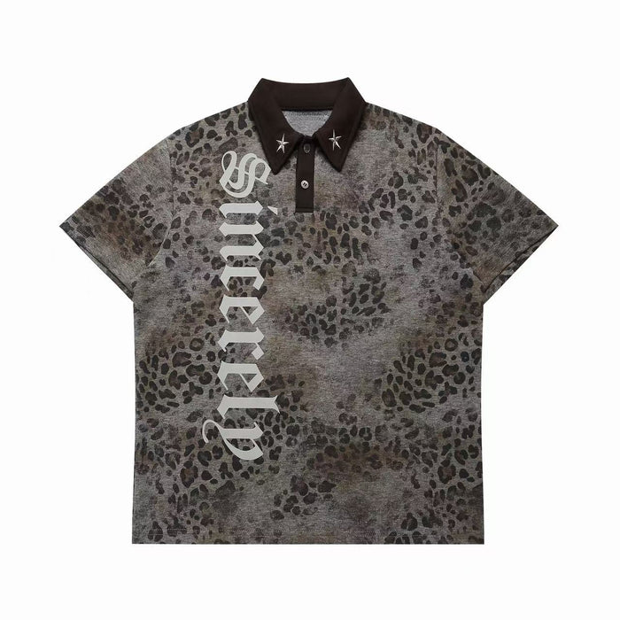 Oversized grey leopard print polo shirt with gothic lettering graphic and metallic star collar pins, front view