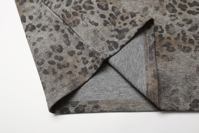 Close-up of oversized leopard print polo tee with grey knit fabric and stitched hem detail
