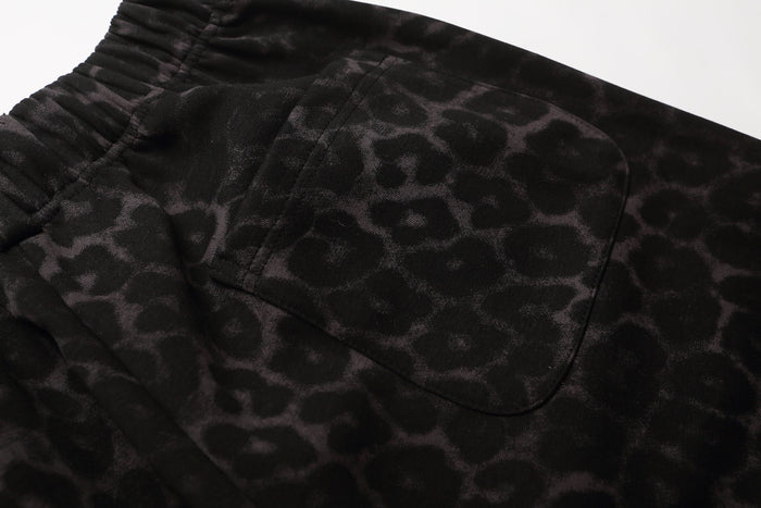 Close-up of black leopard print shorts back pocket and elastic waistband