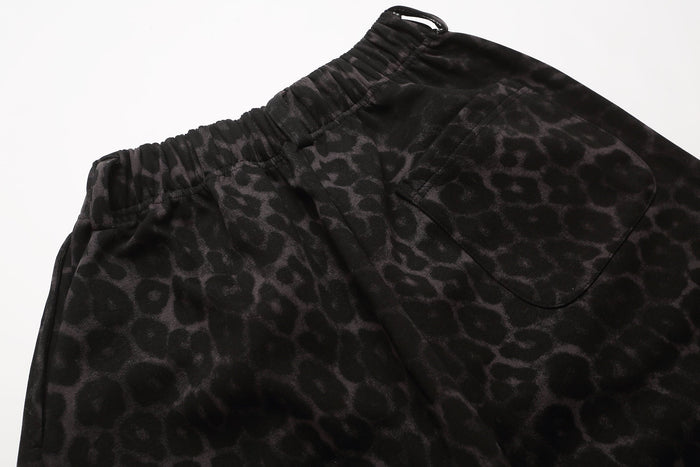 Close-up of black leopard print shorts waistband and patch pocket