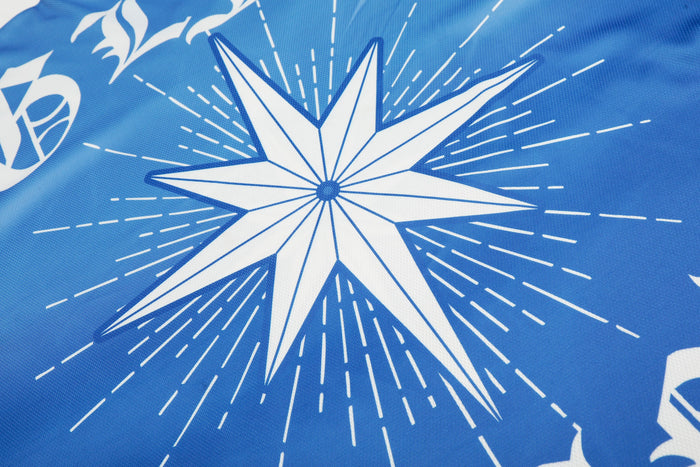 Blue mesh football jersey with a bold white starburst graphic and streetwear-inspired print design